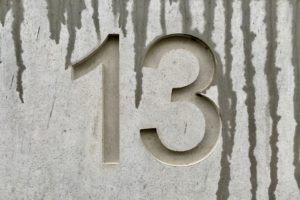 The number thirteen in a concrete wall