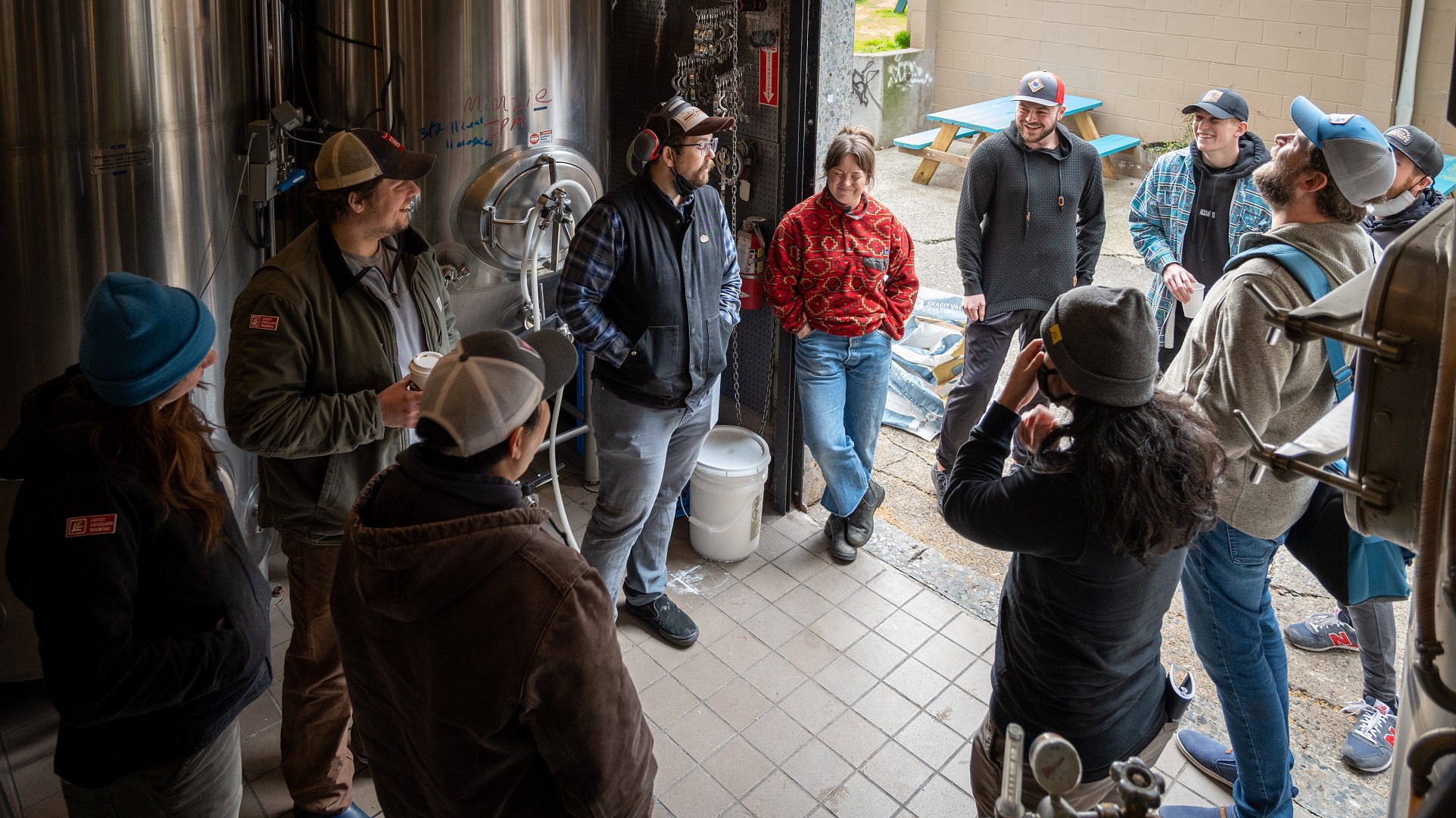The Brew Day crew gathered around as Aaron regales them with tales of beer