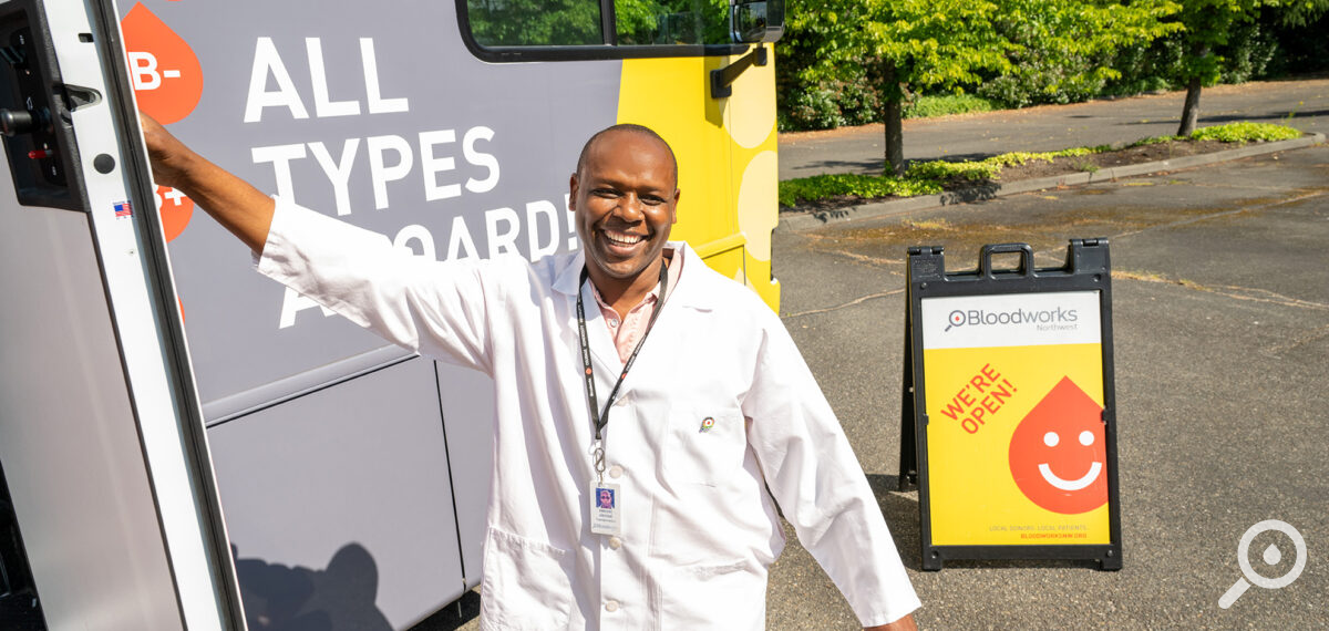 A blood collection specialist welcomes you onto our newest bloodmobile